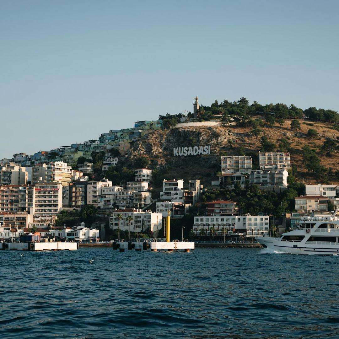 a boat is in the water near a city