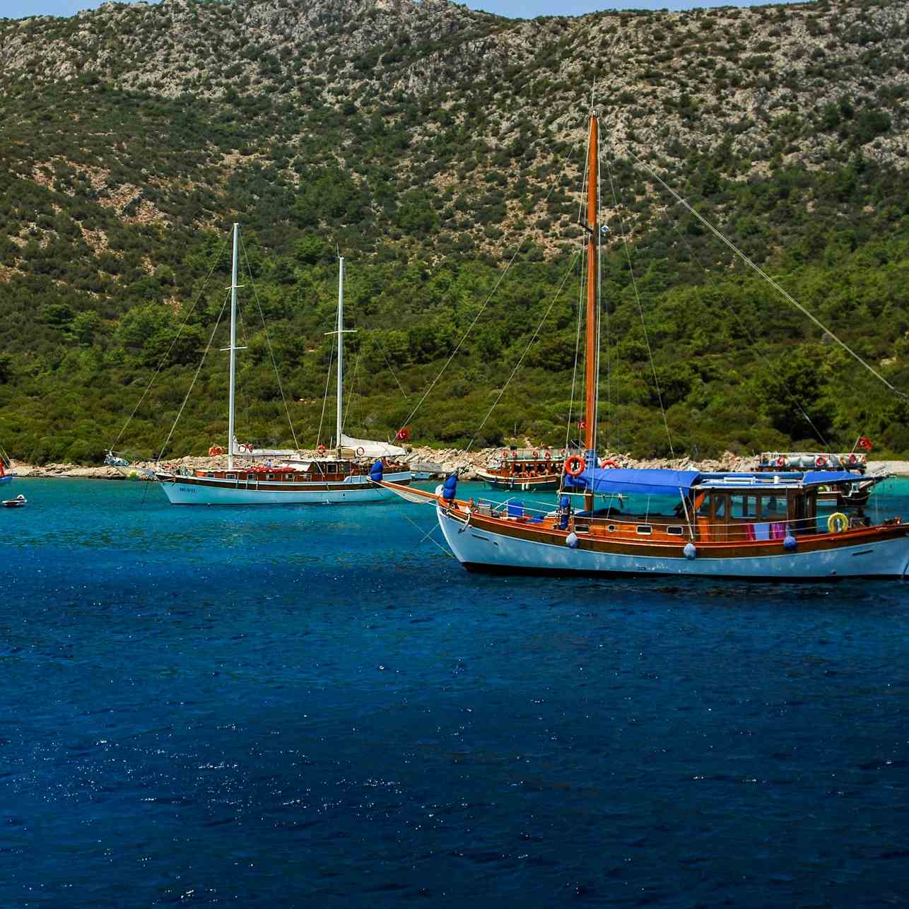 white and blue boat on sea during daytime